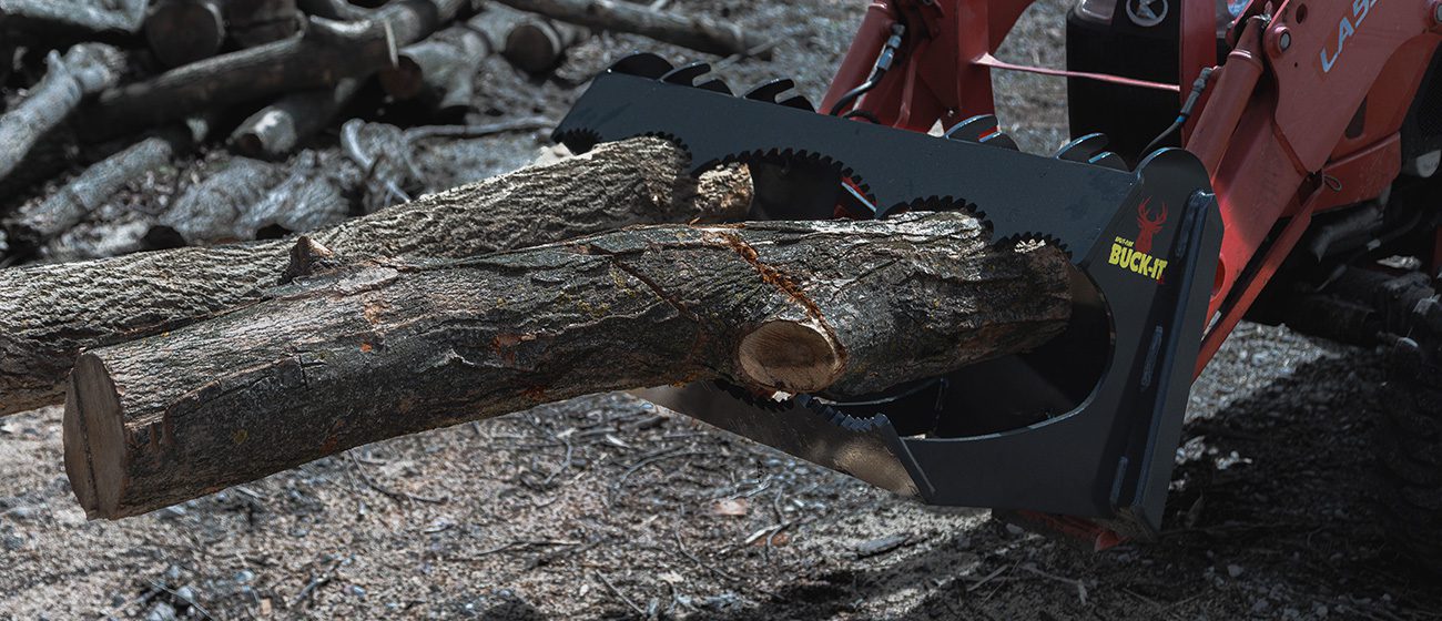 Split-fire Buck-it XL mounted on kubota tractor with logs mounted